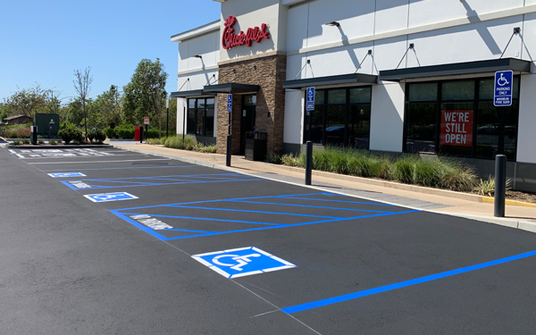 Wide shot of Chick Fil A parking lot that has been recently paved